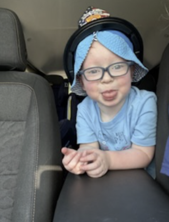 Carter smiling in a blue hat